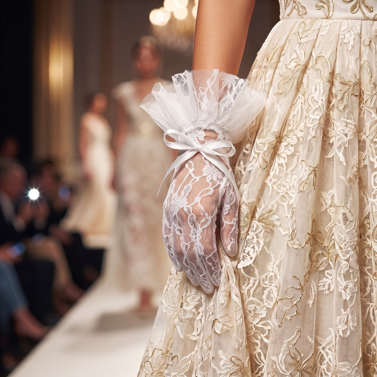 White lace wrist gloves with a soft tulle bow cuff and a single pearl.
