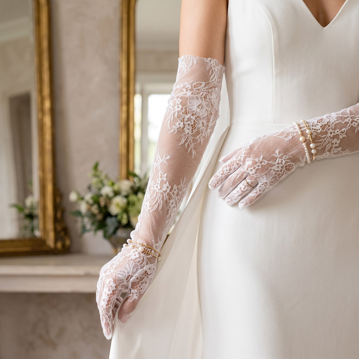 Elbow-length white floral lace gloves with a banded top edge.