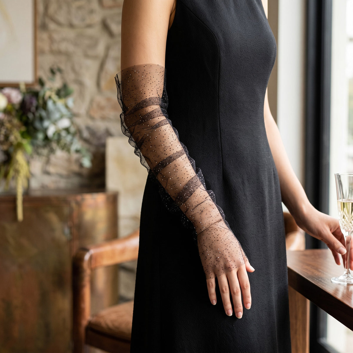 Ruched black tulle arm cuffs flecked with fine glitter, fingerless, ruffle edge.