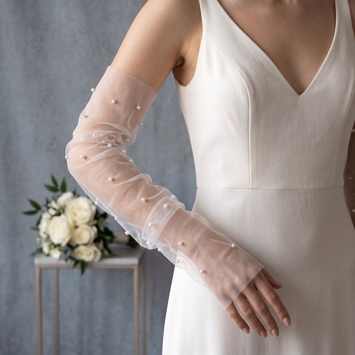 White tulle arm cuffs with small pearls scattered widely, fingerless, no ruffle.