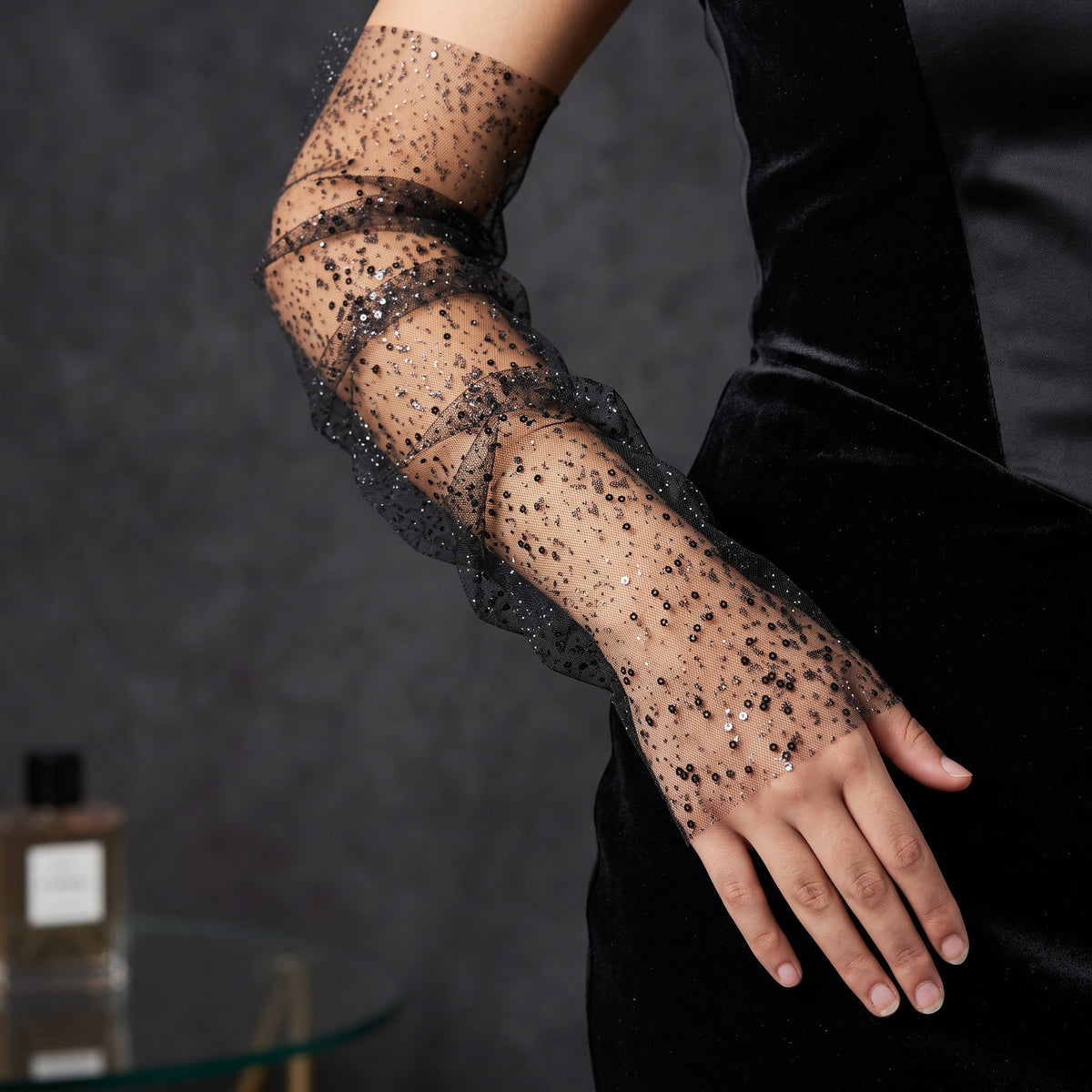 Black tulle arm cuffs sewn with small sequins, fingerless, ruffle edge.