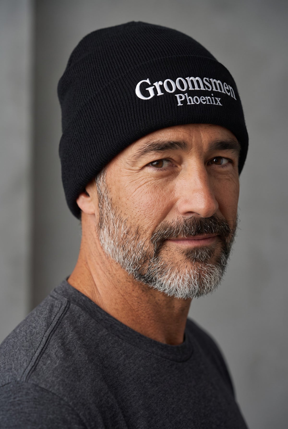 Model wearing a black Eddia beanie with custom cuff embroidery