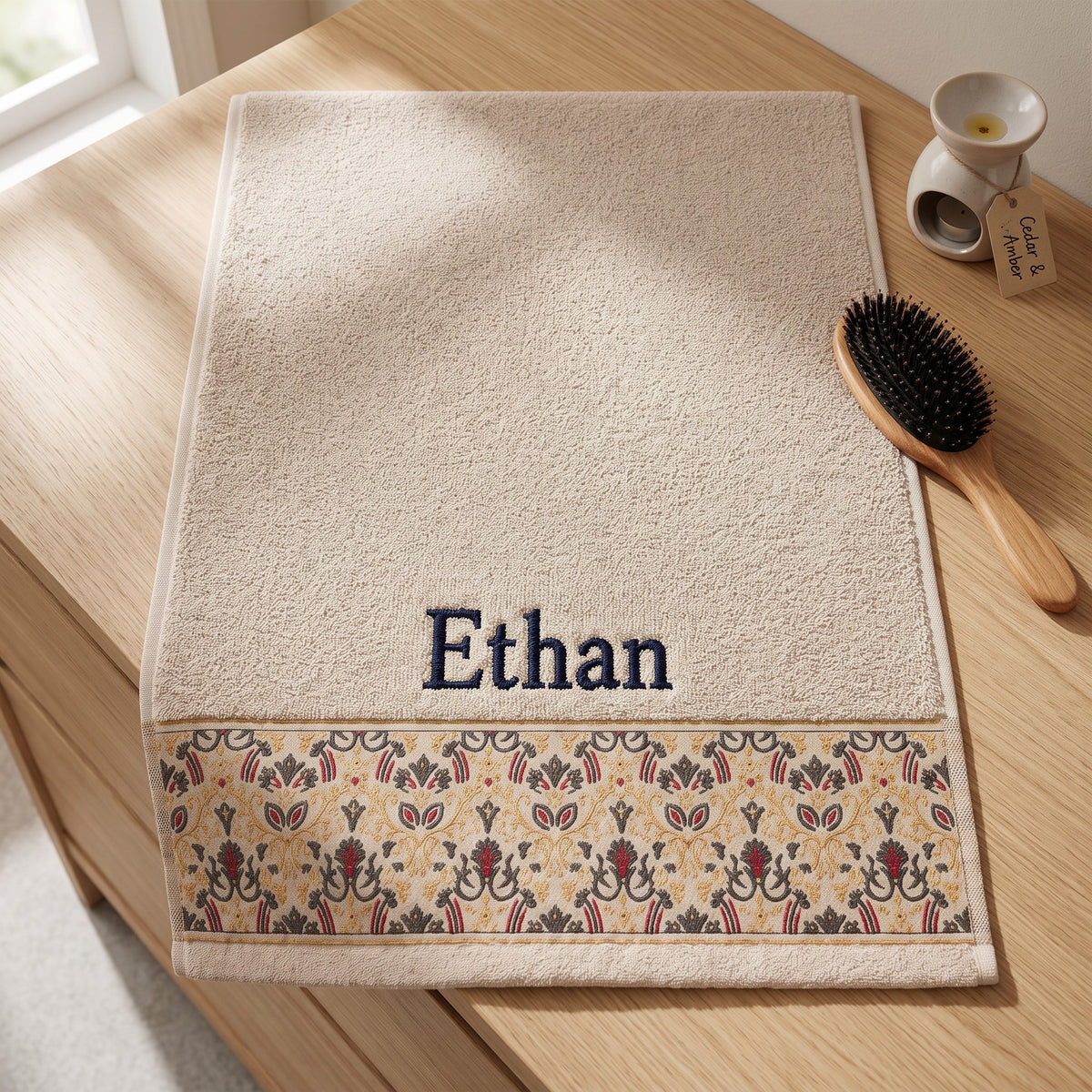 Ethan personalized hair towel, navy serif embroidery on cream cotton with a patterned border — photo 4