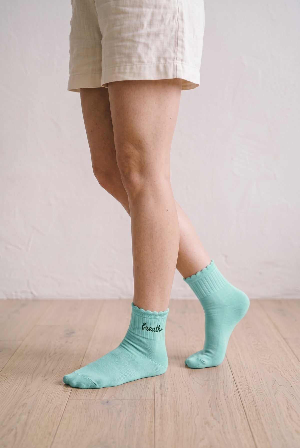 Model wearing light mint embroidered ruffle ankle socks, second view