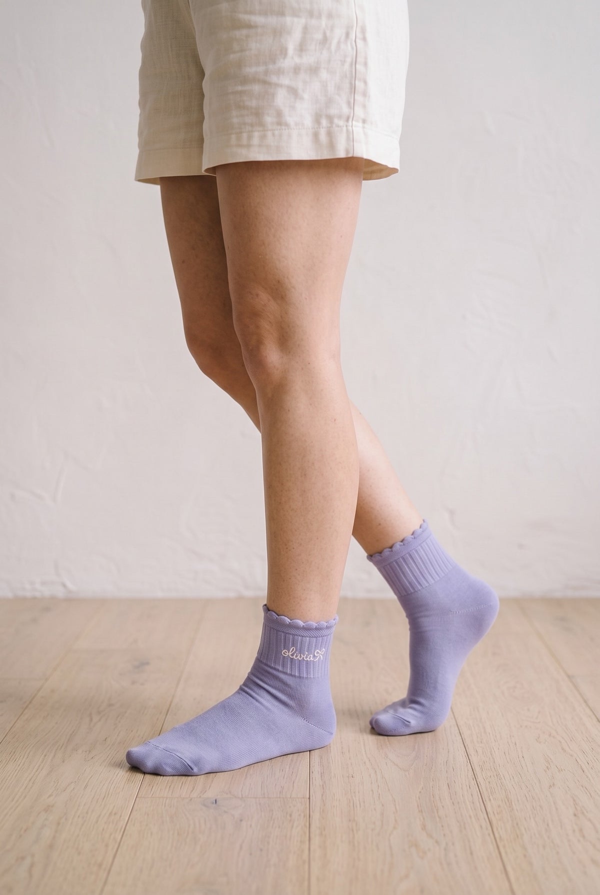 Model wearing purple lilac embroidered ruffle ankle socks, second view