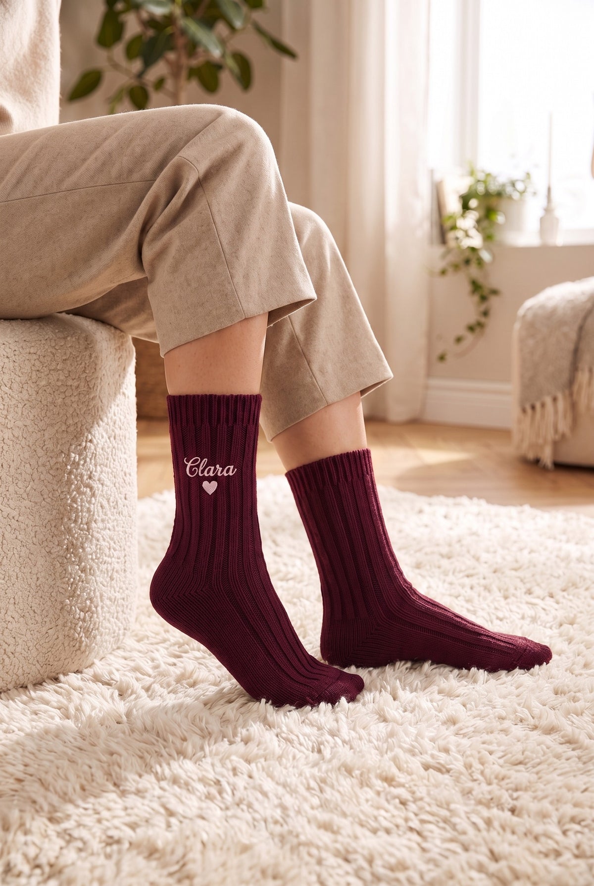 Model wearing burgundy embroidered women's wool socks