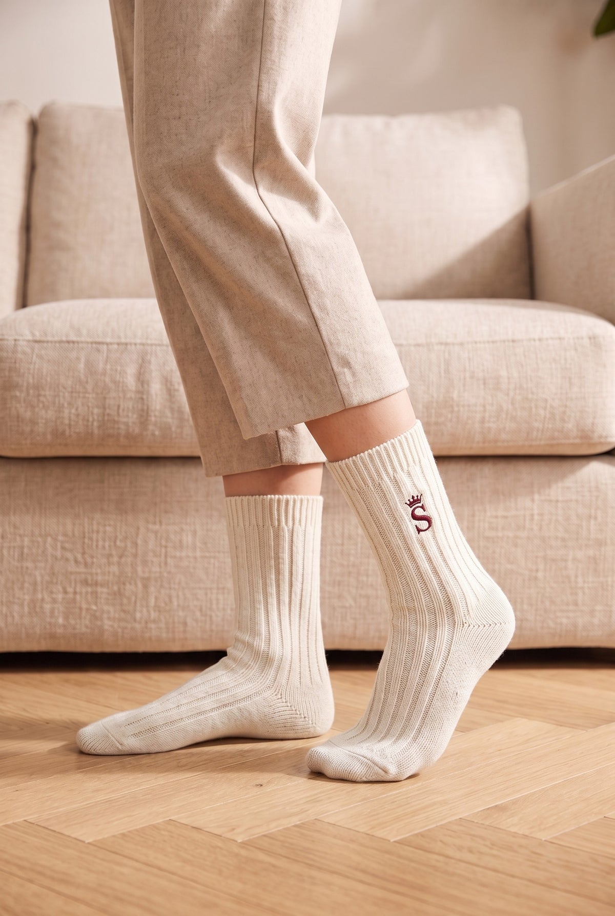 Model wearing off white embroidered women's wool socks, second view