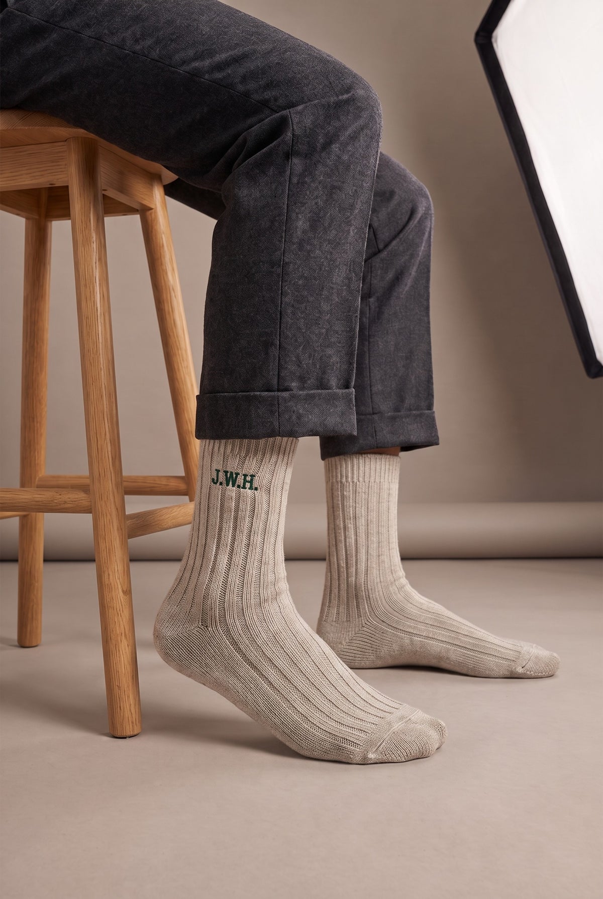 Model wearing beige embroidered men's wool socks