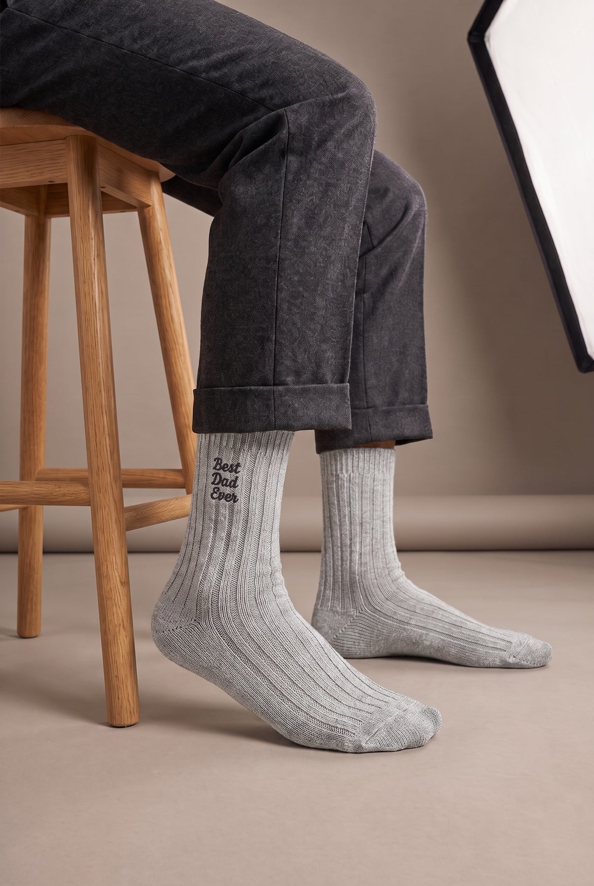 Model wearing light grey embroidered men's wool socks