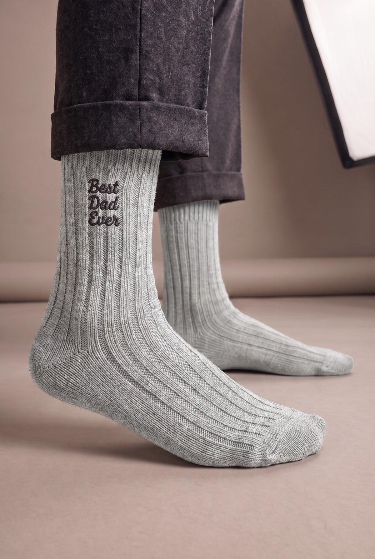 Model wearing light grey embroidered men's wool socks, second view