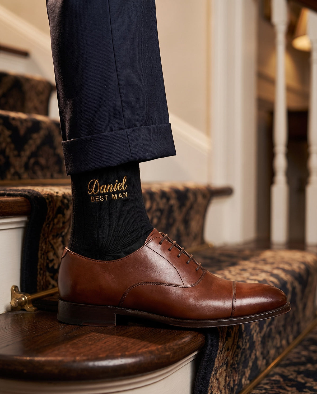 Model wearing black embroidered groom dress socks, second view