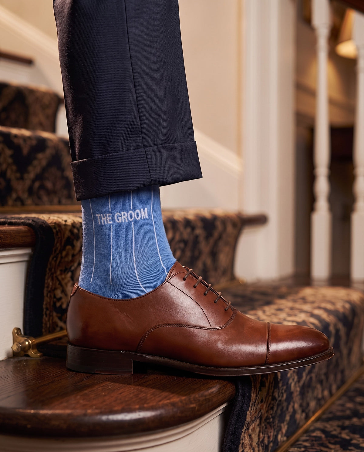 Model wearing blue embroidered groom dress socks, second view