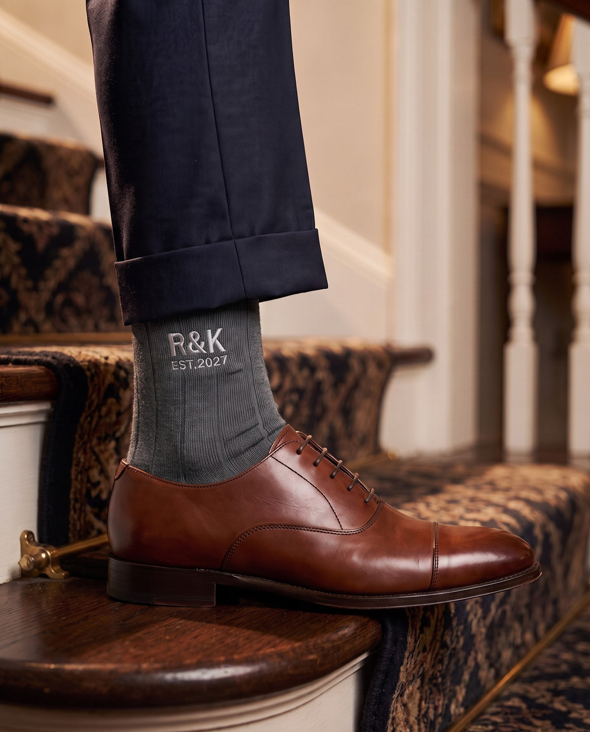 Model wearing charcoal embroidered groom dress socks, second view