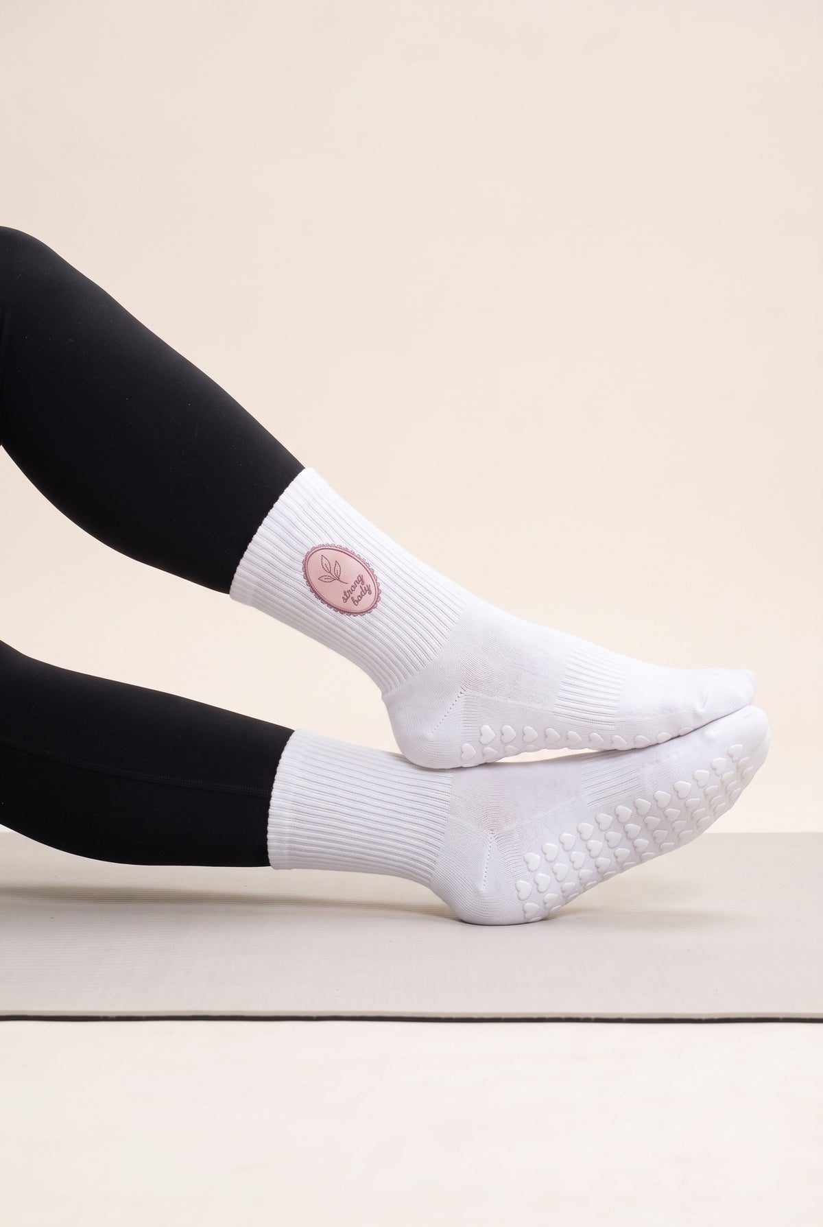Optical White pilates grip socks, worn, side view — embroidered to order