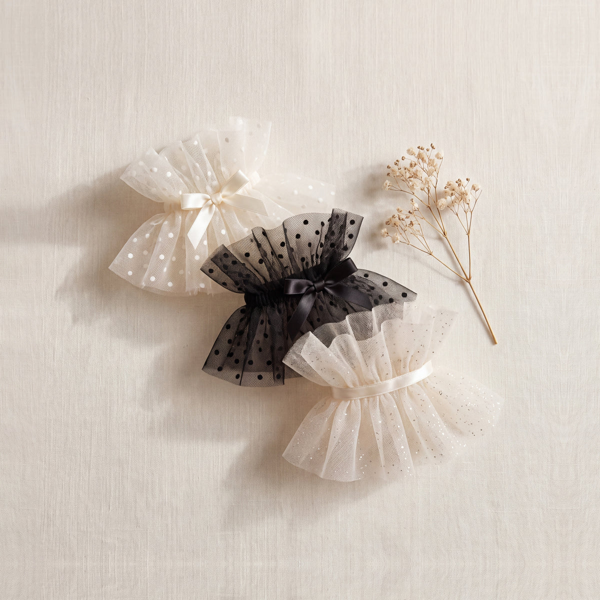 Black and ivory polka dot tulle ankle cuffs with satin bows and an ivory glitter tulle ruffle ankle cuff — Eddia