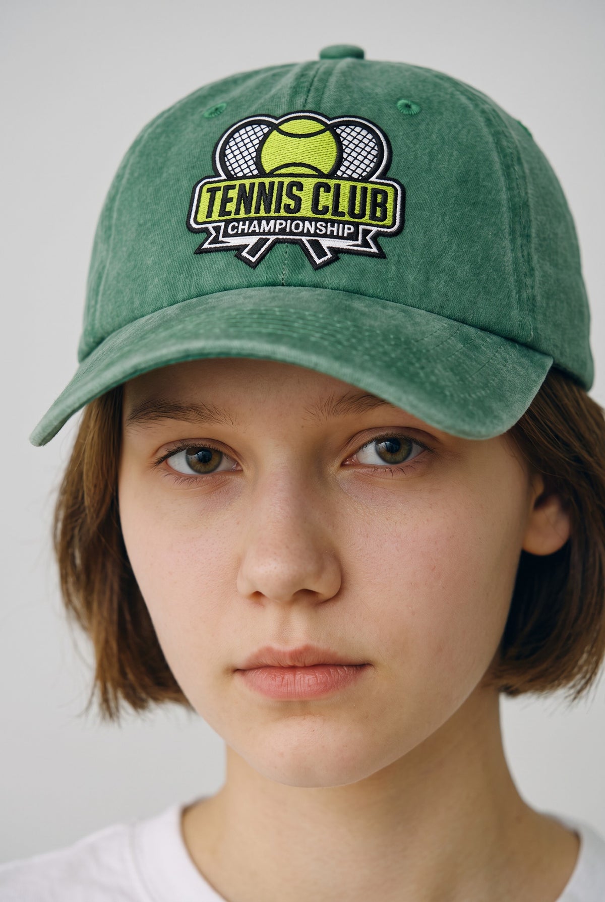 Tennis Club Hat worn by a model, front view
