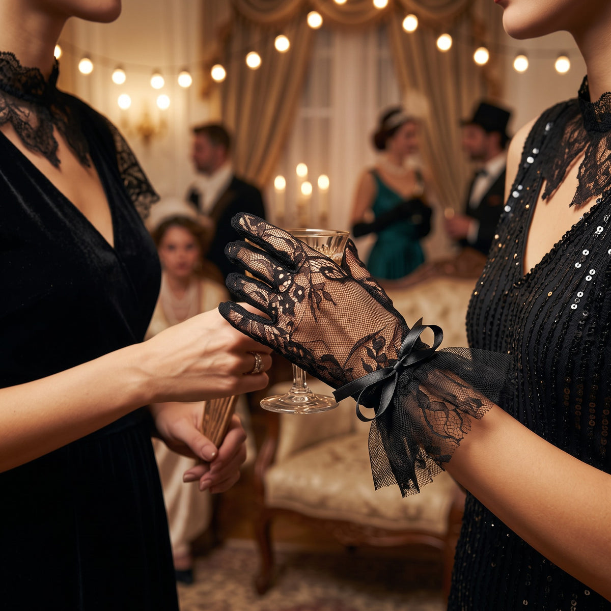 Black floral lace wrist gloves with a black tulle ruffle cuff and satin bow.