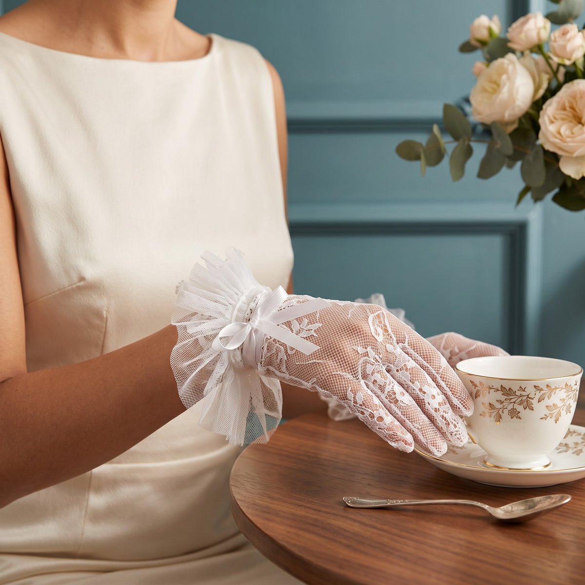 White scalloped lace wrist gloves with a compact pleated tulle rosette cuff.