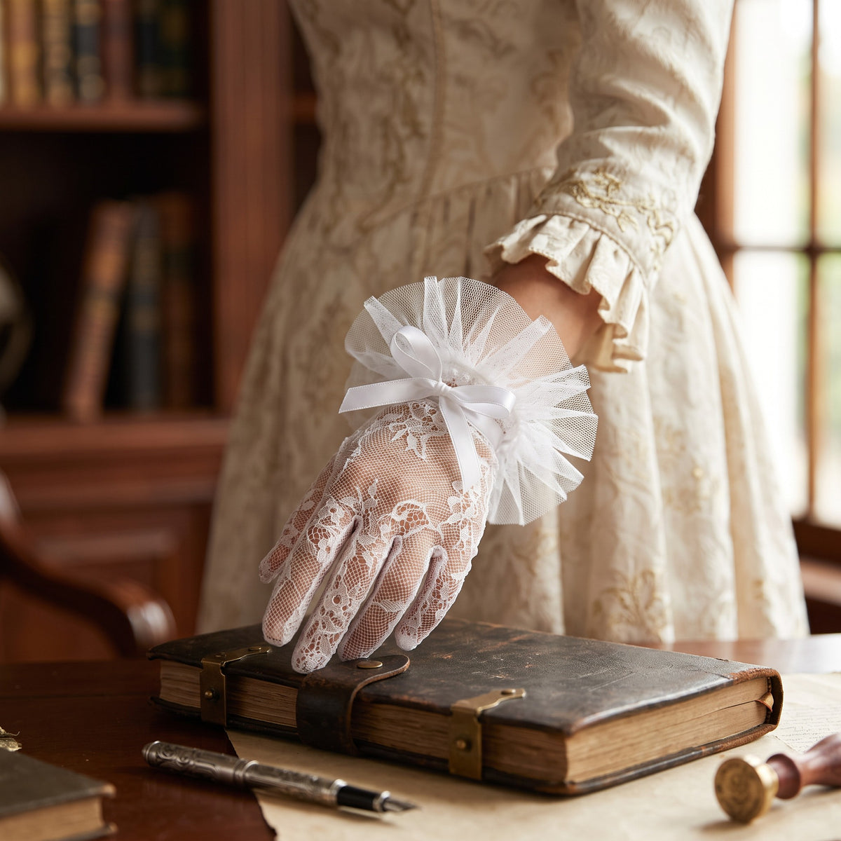 White scalloped lace wrist gloves with a compact pleated tulle rosette cuff.