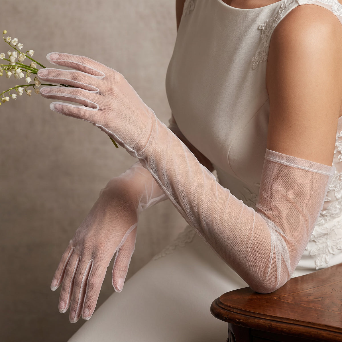 Elbow-length white sheer tulle gloves, plain and unlined, fingers covered.