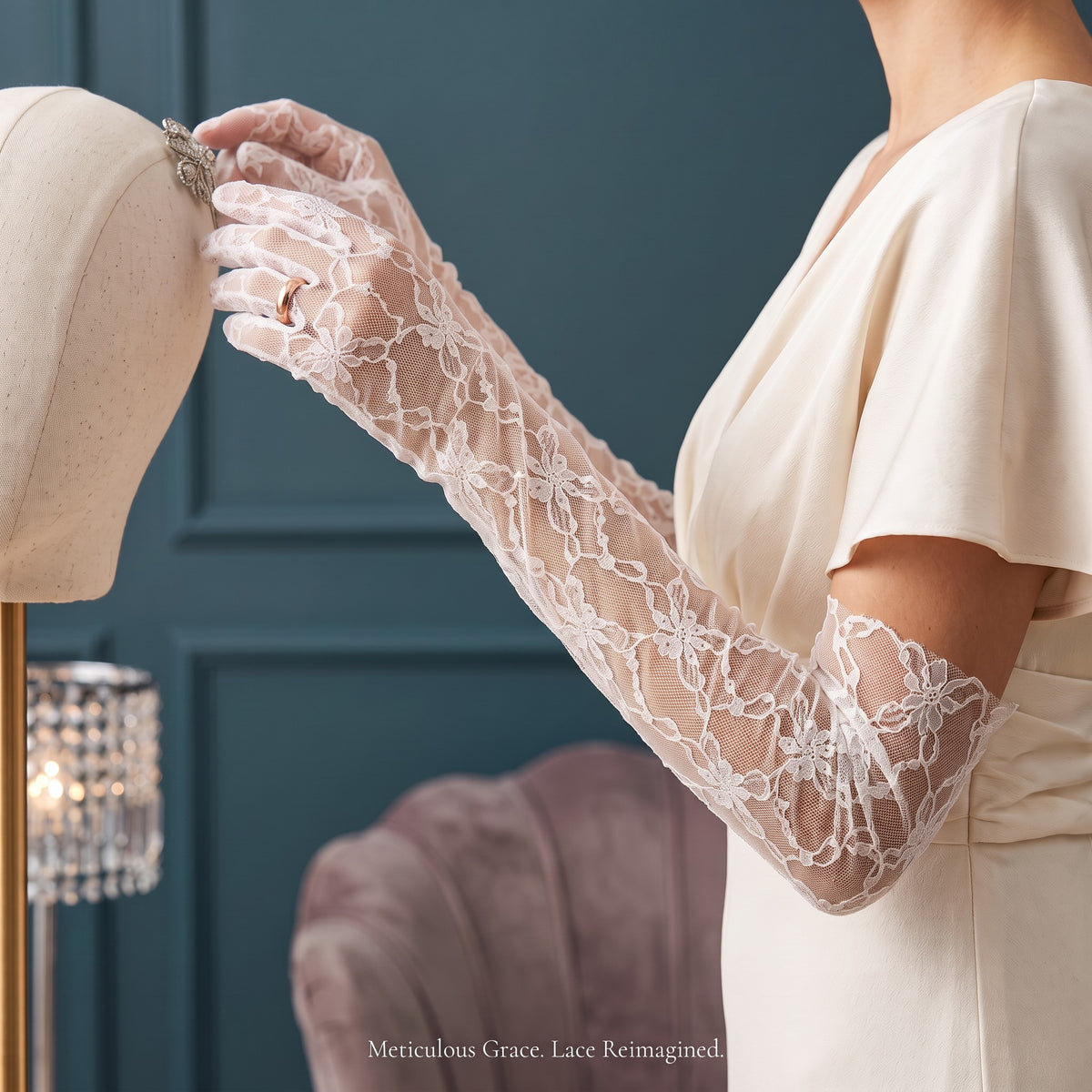 Above-elbow white gloves in a bold open floral lace, fingers covered.