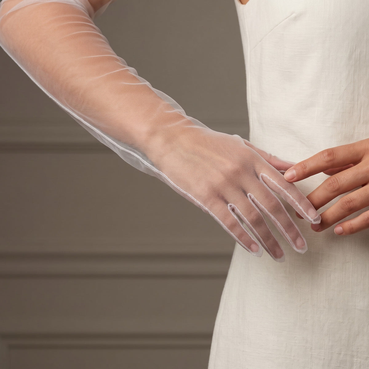 Above-elbow white sheer tulle gloves, plain and unlined, fingers covered.