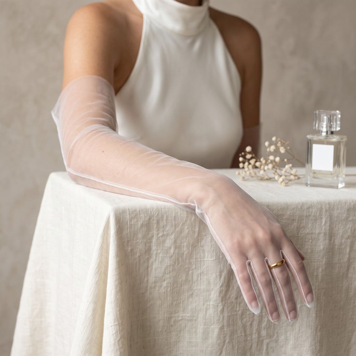 Above-elbow white sheer tulle gloves, plain and unlined, fingers covered.