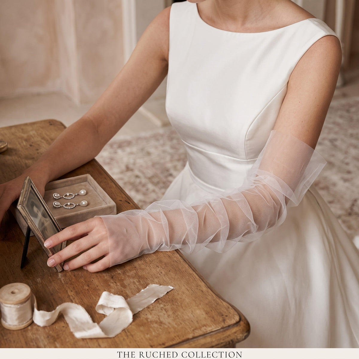 Ruched white tulle arm cuffs, fingerless, plain with no trim.