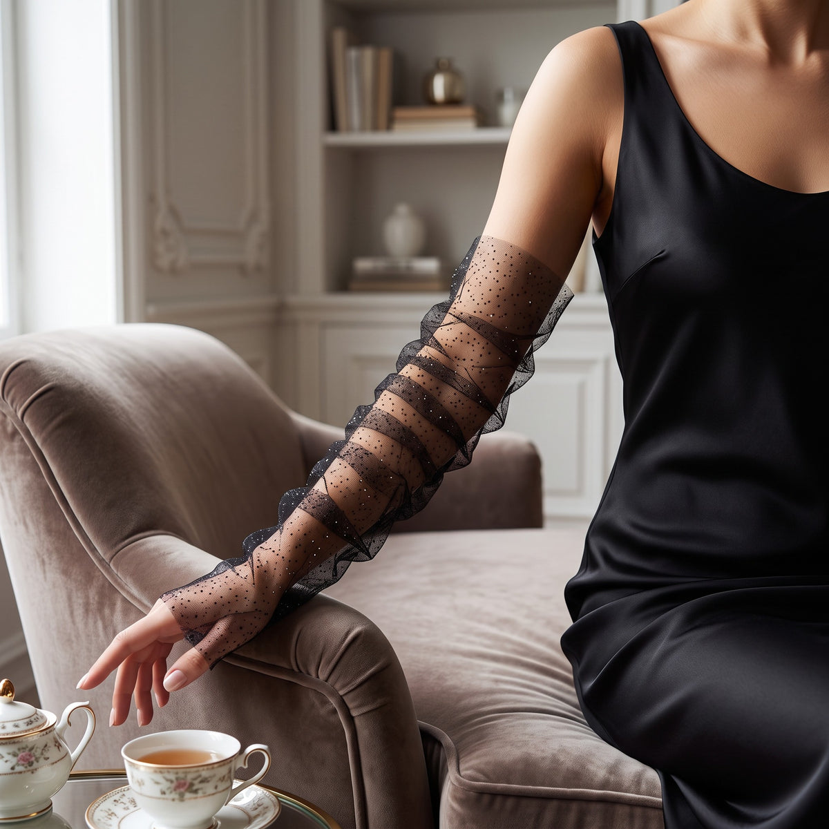Ruched black tulle arm cuffs flecked with fine glitter, fingerless, ruffle edge.