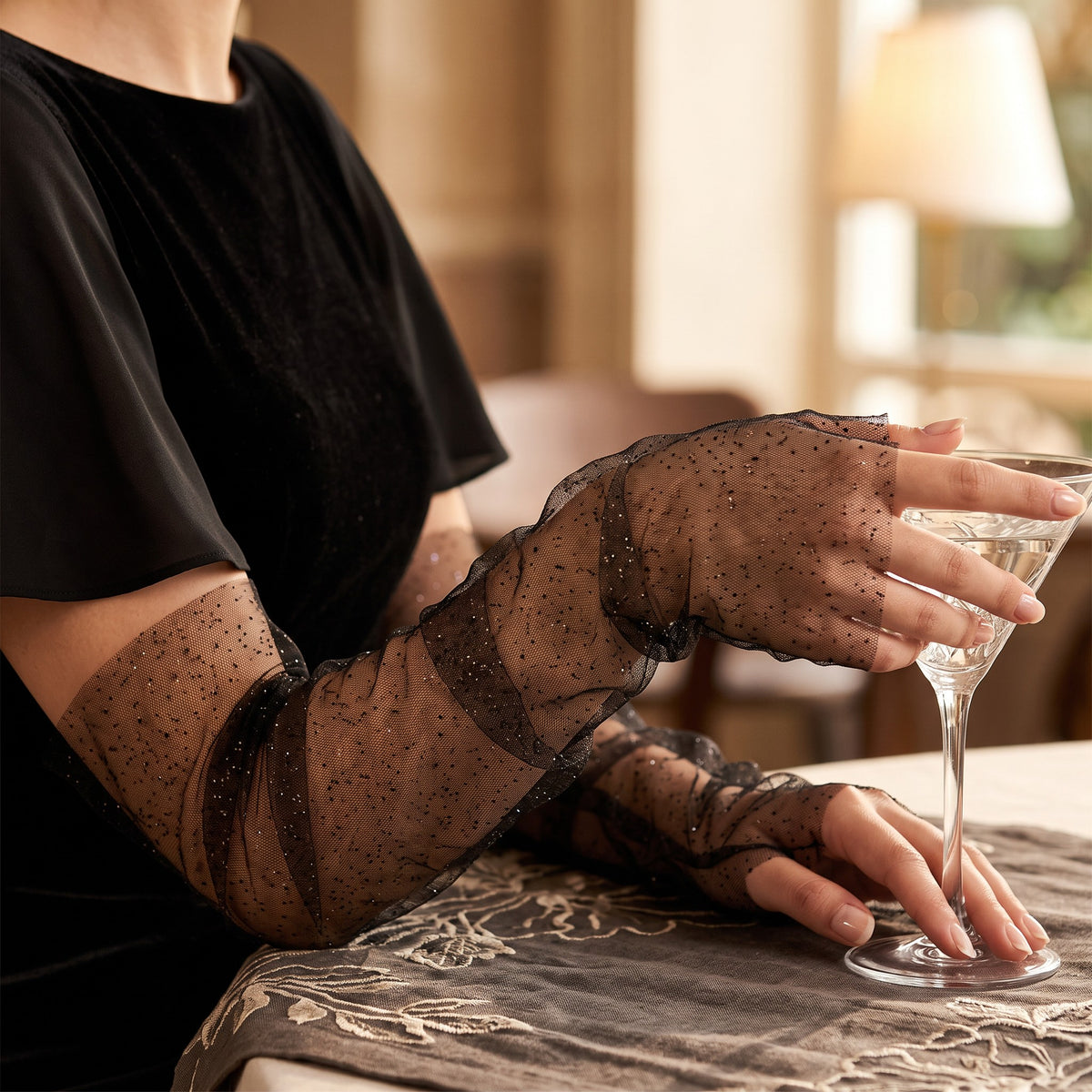 Ruched black tulle arm cuffs flecked with fine glitter, fingerless, ruffle edge.