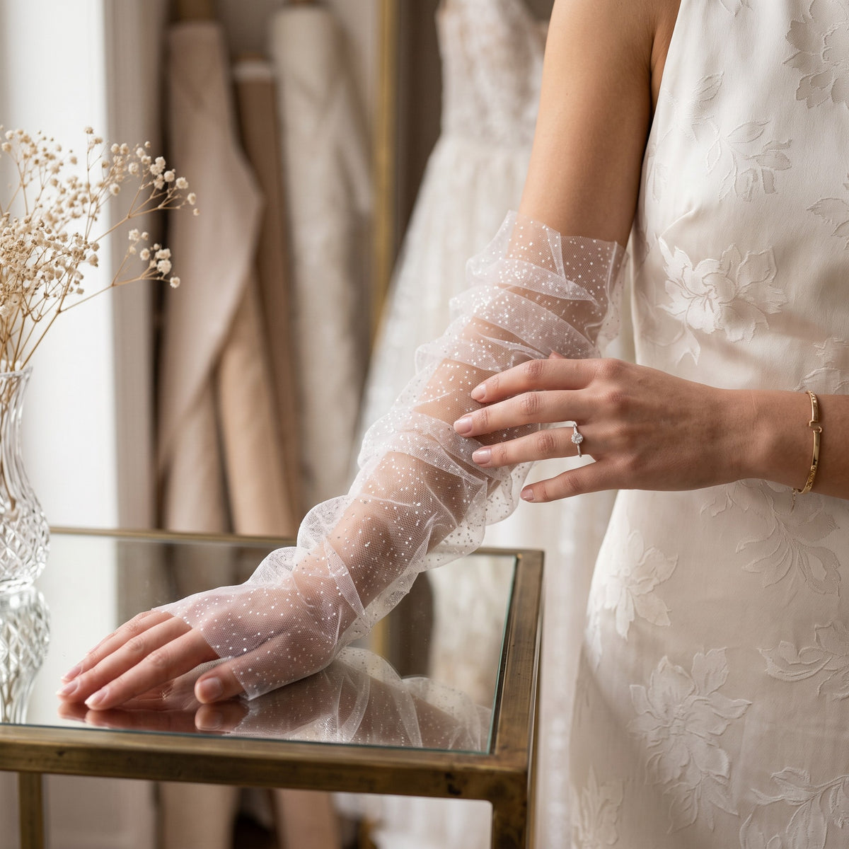Ruched white tulle arm cuffs flecked with fine glitter, fingerless, ruffle edge.