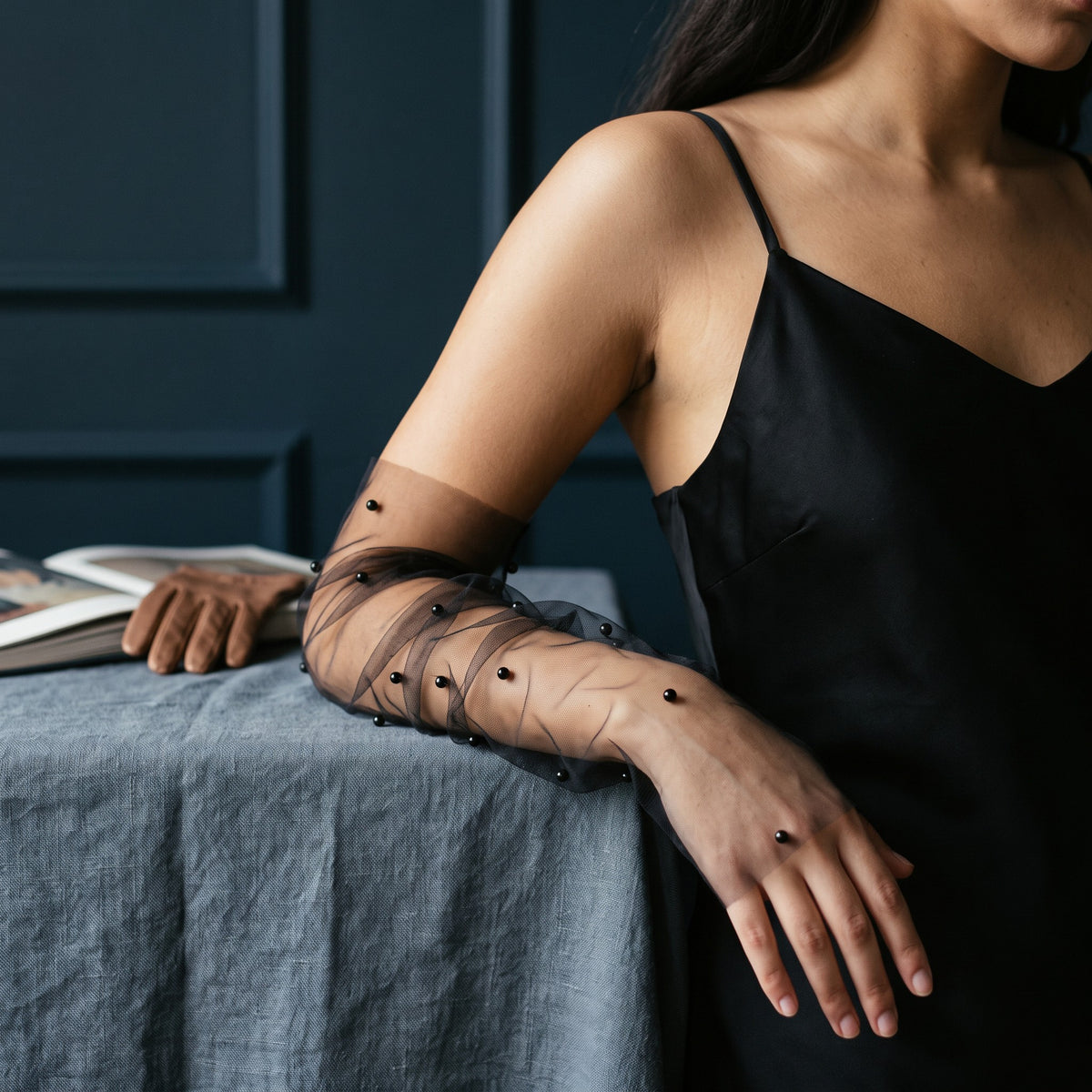 Black tulle arm cuffs scattered with black pearls, fingerless, ruched.