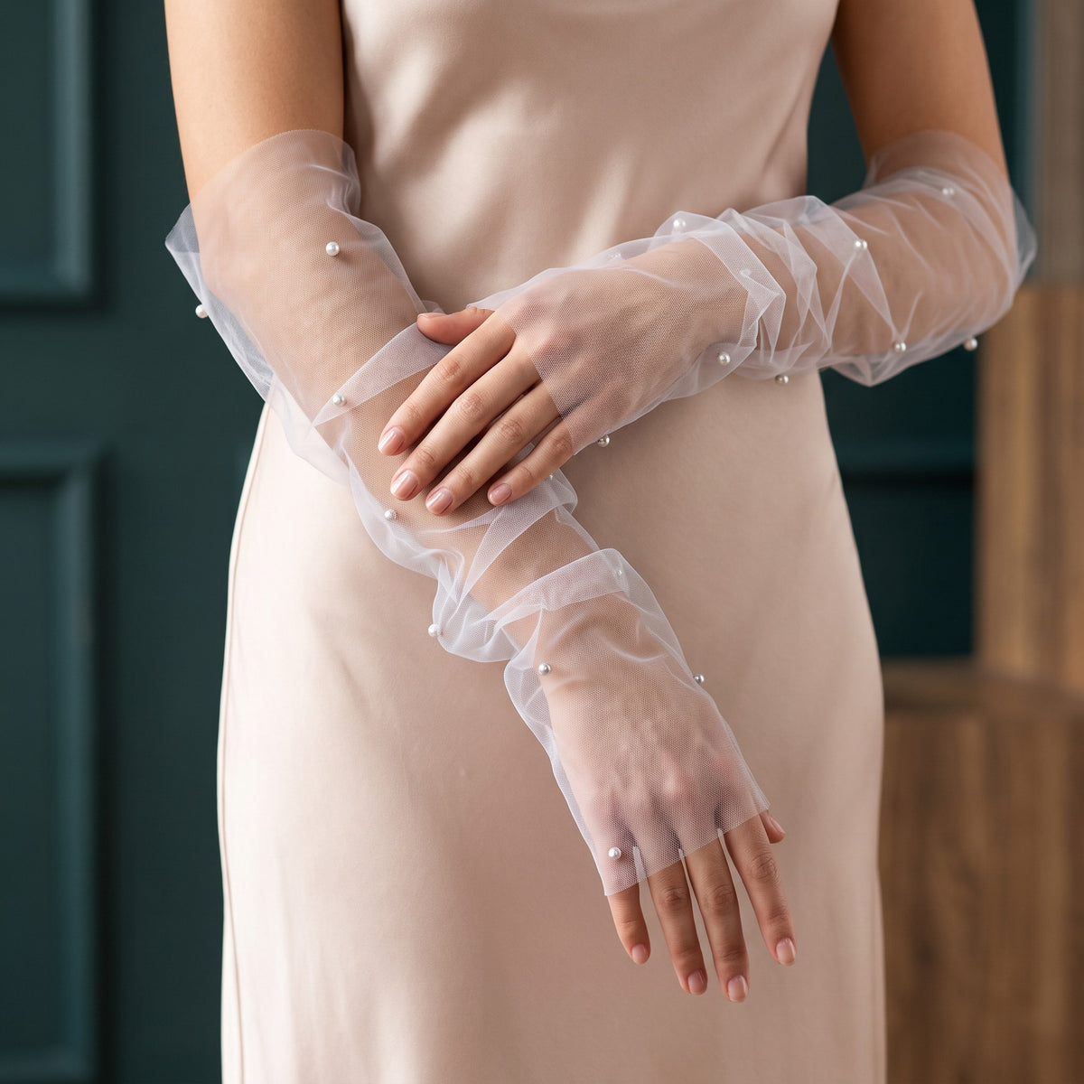 White tulle arm cuffs with scattered pearls and a ruffle edge, fingerless.