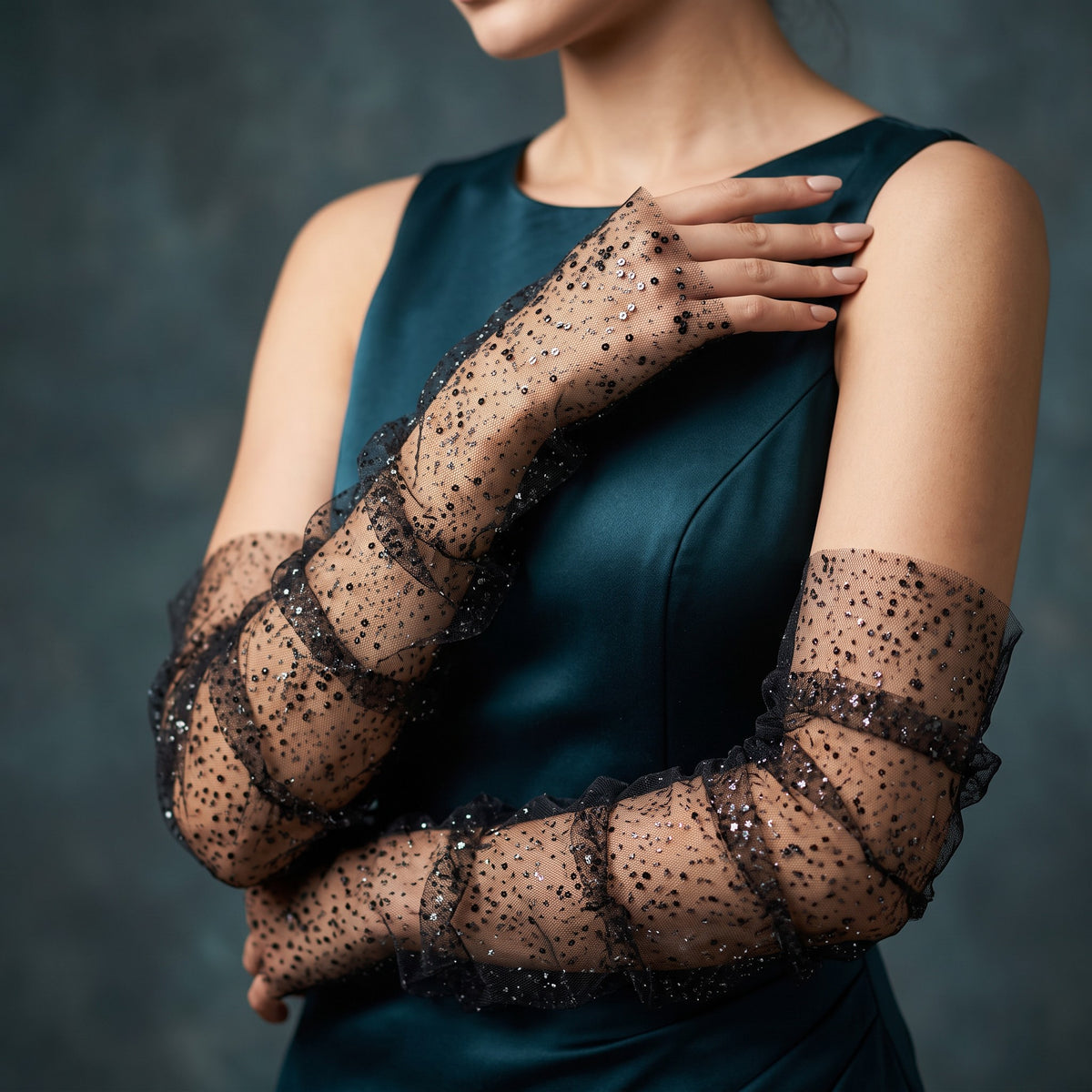 Black tulle arm cuffs sewn with small sequins, fingerless, ruffle edge.