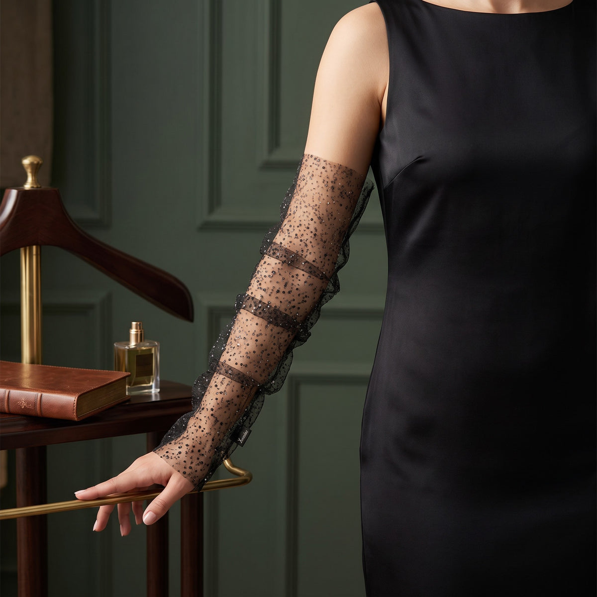 Black tulle arm cuffs sewn with small sequins, fingerless, ruffle edge.