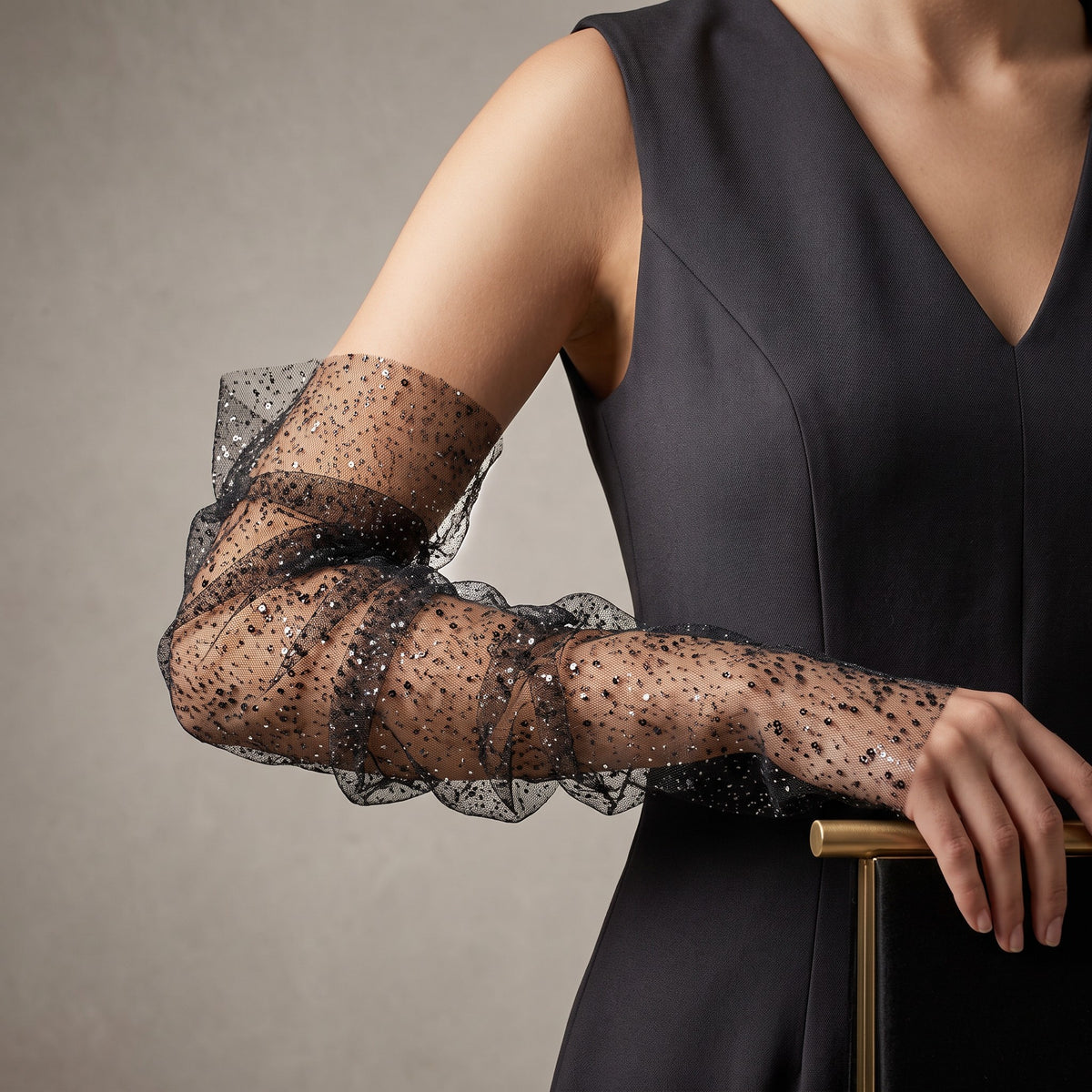 Black tulle arm cuffs sewn with small sequins, fingerless, ruffle edge.