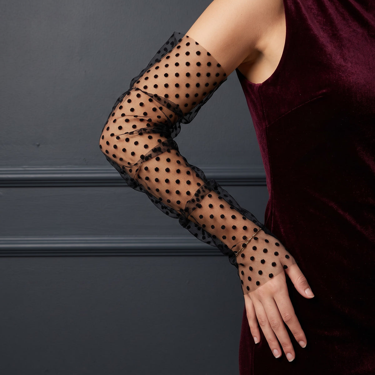 Black polka dot tulle arm cuffs, fingerless, ruched with a ruffle edge.