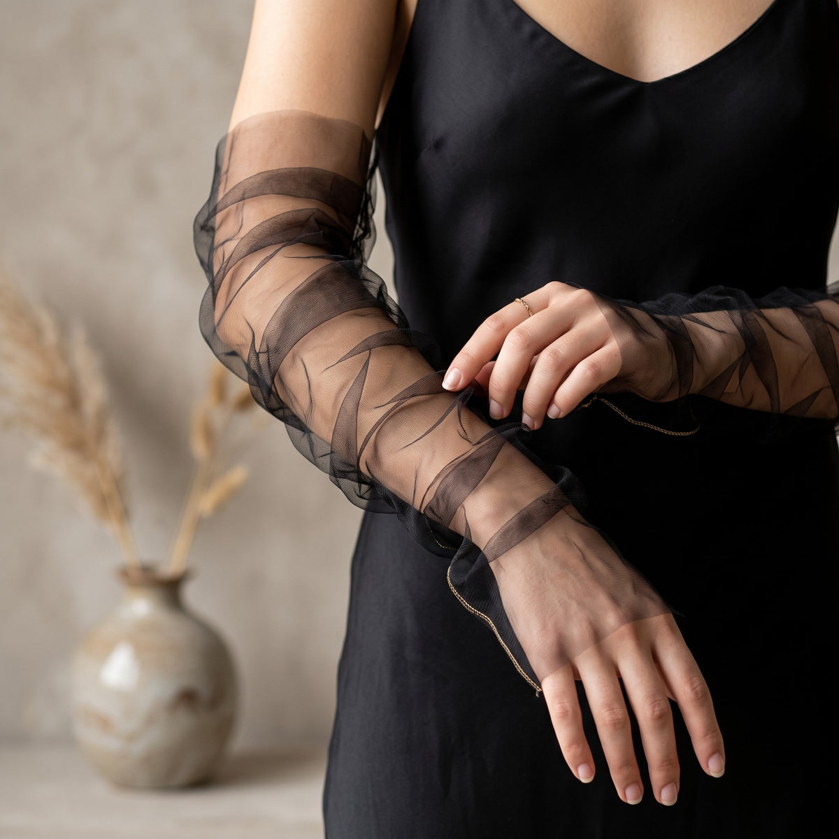 Ruched black tulle arm cuffs, fingerless, plain with a ruffle edge.