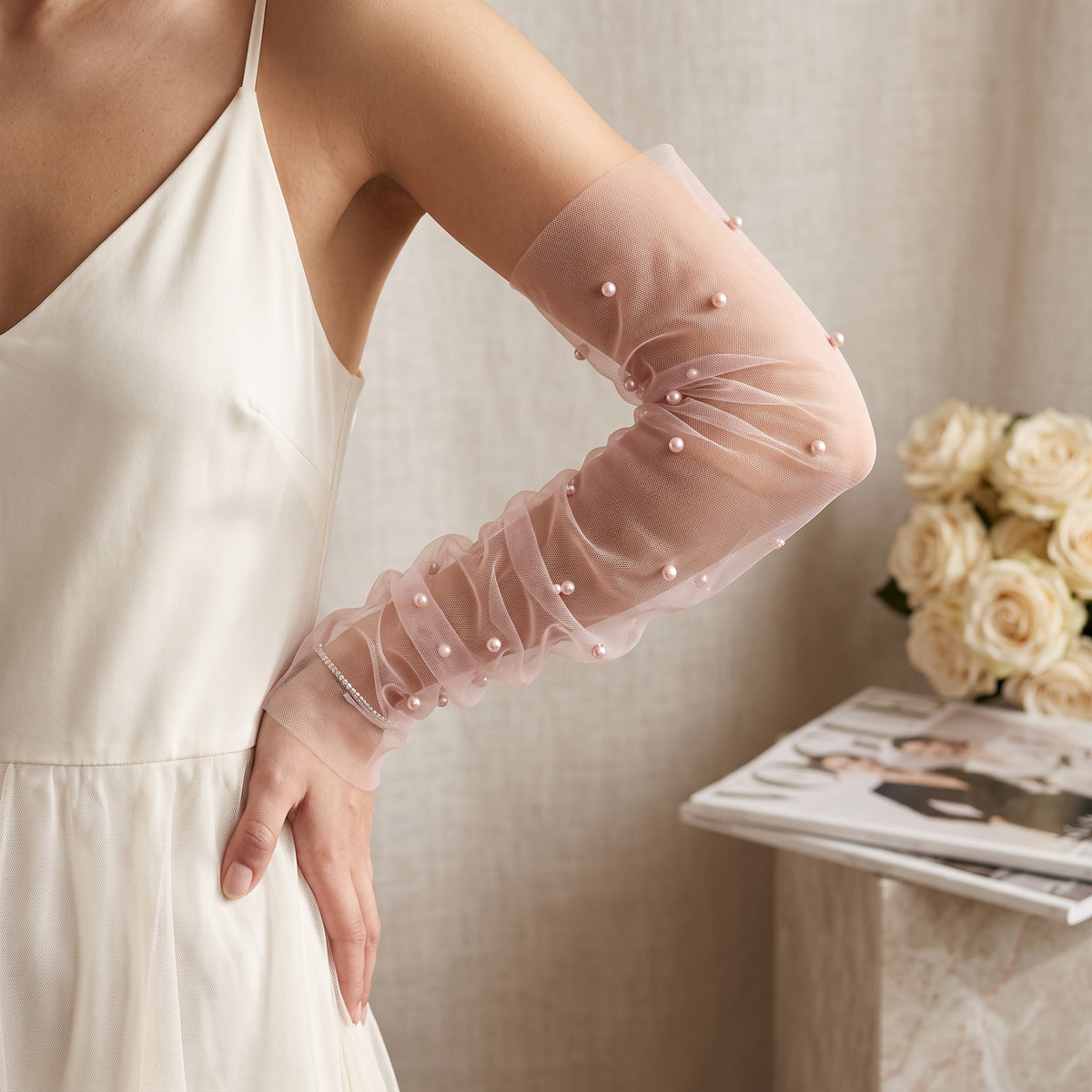 White tulle arm cuffs set with larger pearls, fingerless, densely ruched.