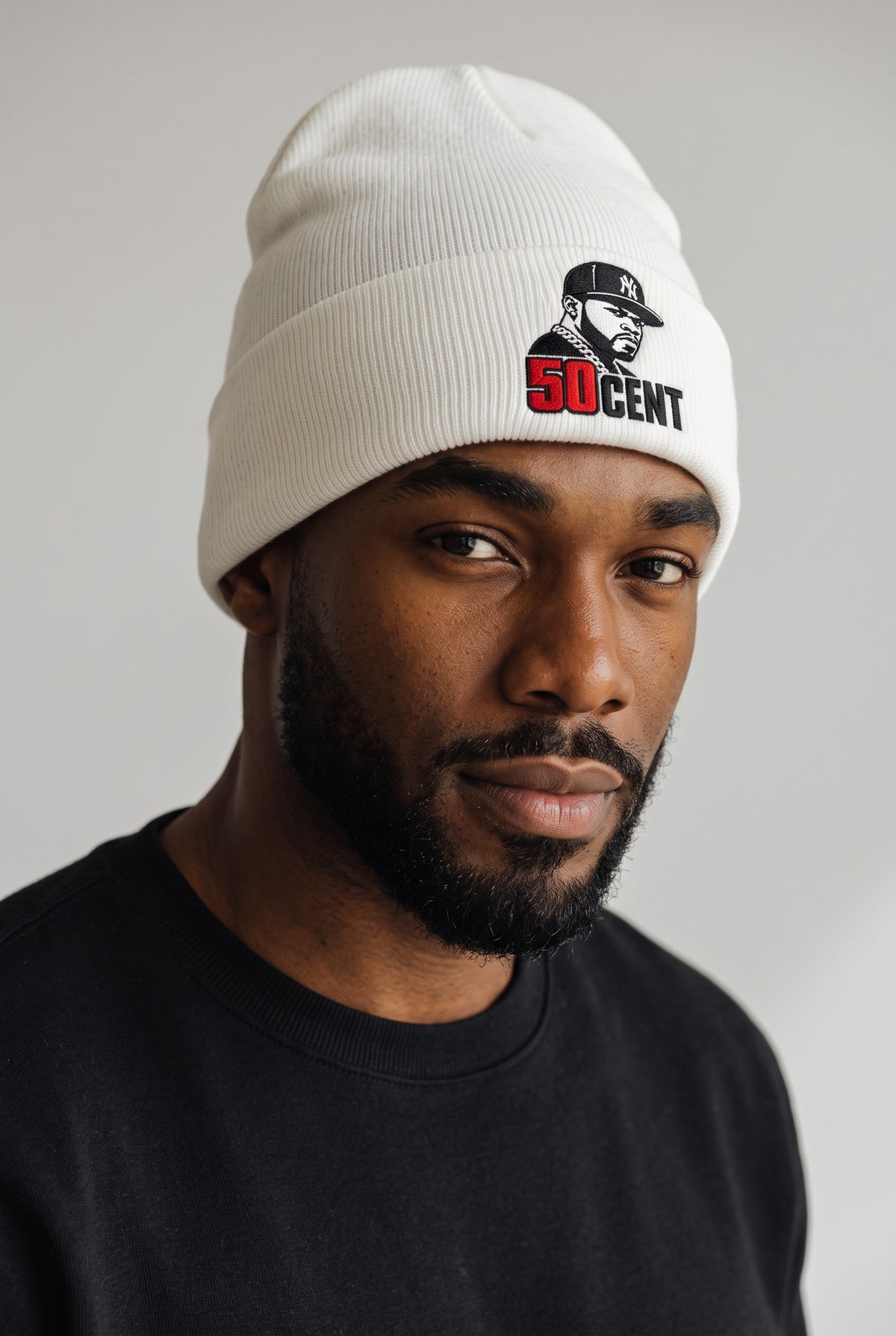 Model wearing a white Eddia beanie with custom cuff embroidery