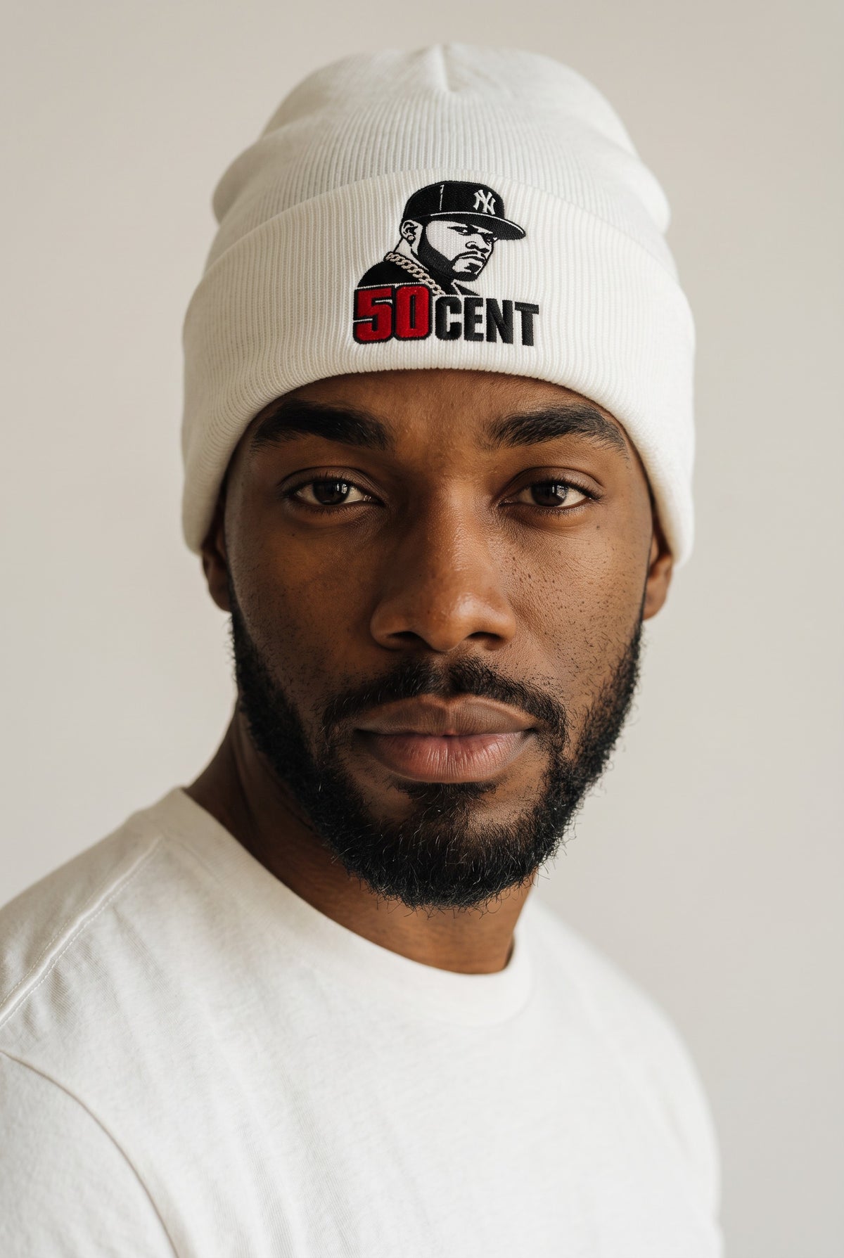 Model wearing a white Eddia beanie with custom cuff embroidery
