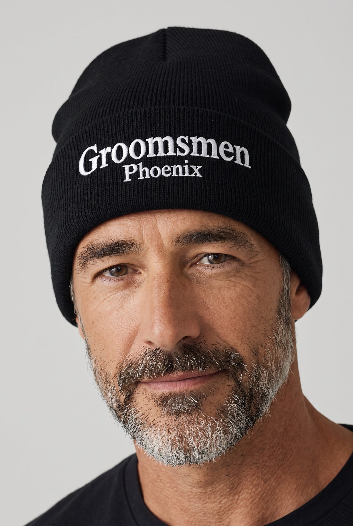 Model wearing a black Eddia beanie with custom cuff embroidery