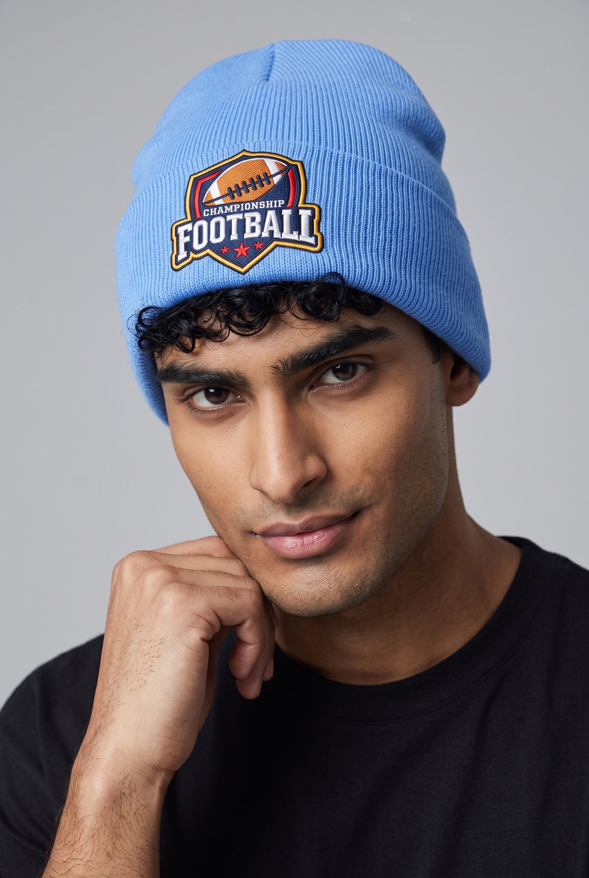 Model wearing a sky blue Eddia beanie with custom cuff embroidery