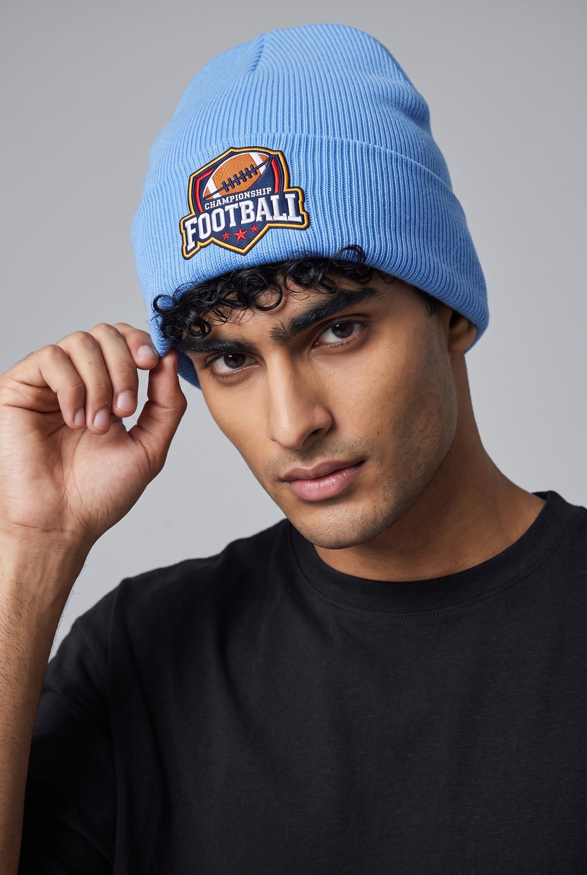 Model wearing a sky blue Eddia beanie with custom cuff embroidery