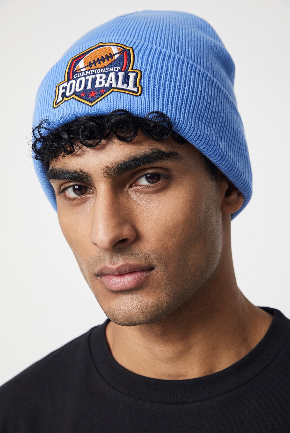 Model wearing a sky blue Eddia beanie with custom cuff embroidery