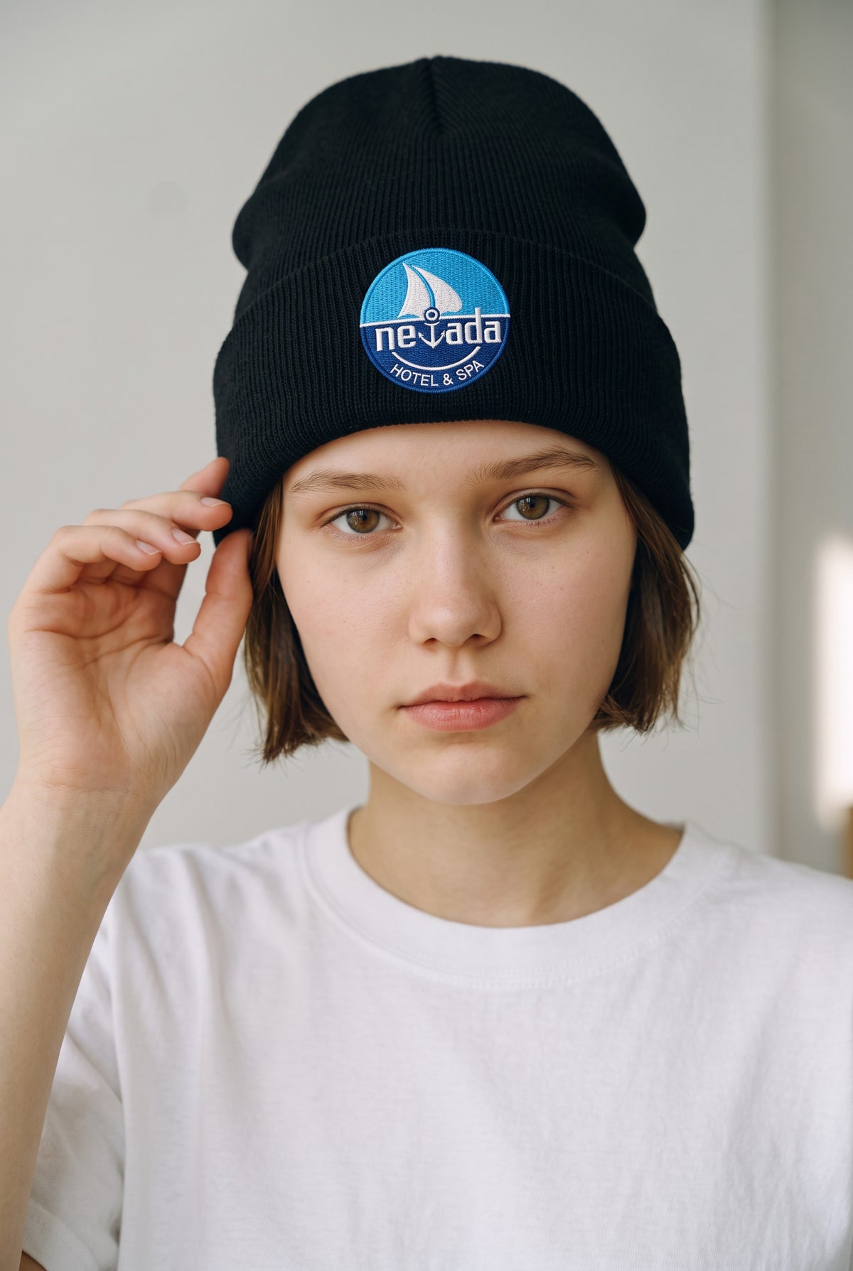 Model wearing a black Eddia beanie with custom cuff embroidery