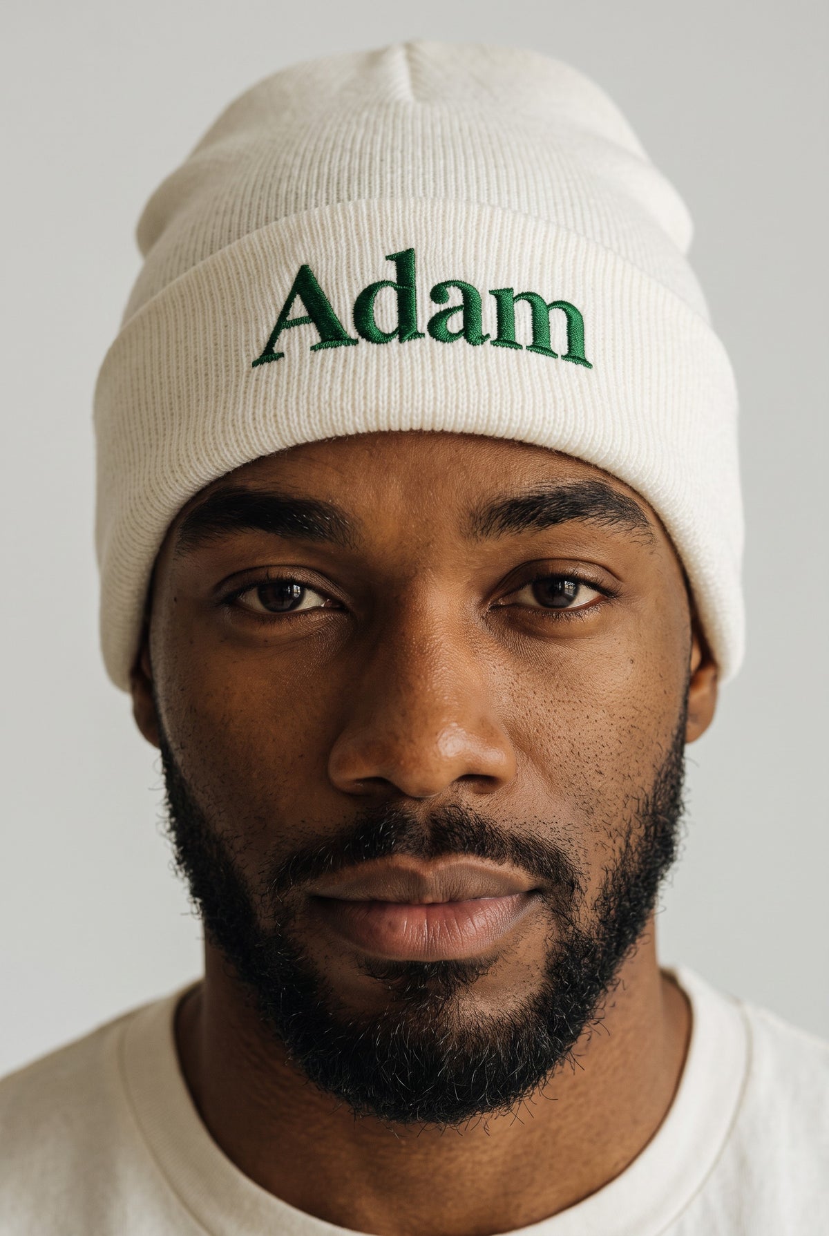 White cuffed knit beanie embroidered with a name in green thread — Eddia Socks