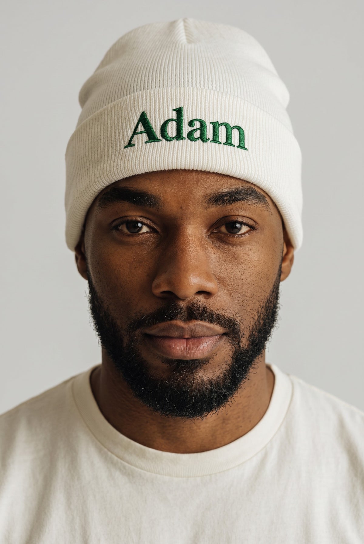 White cuffed knit beanie embroidered with a name in green thread — Eddia Socks