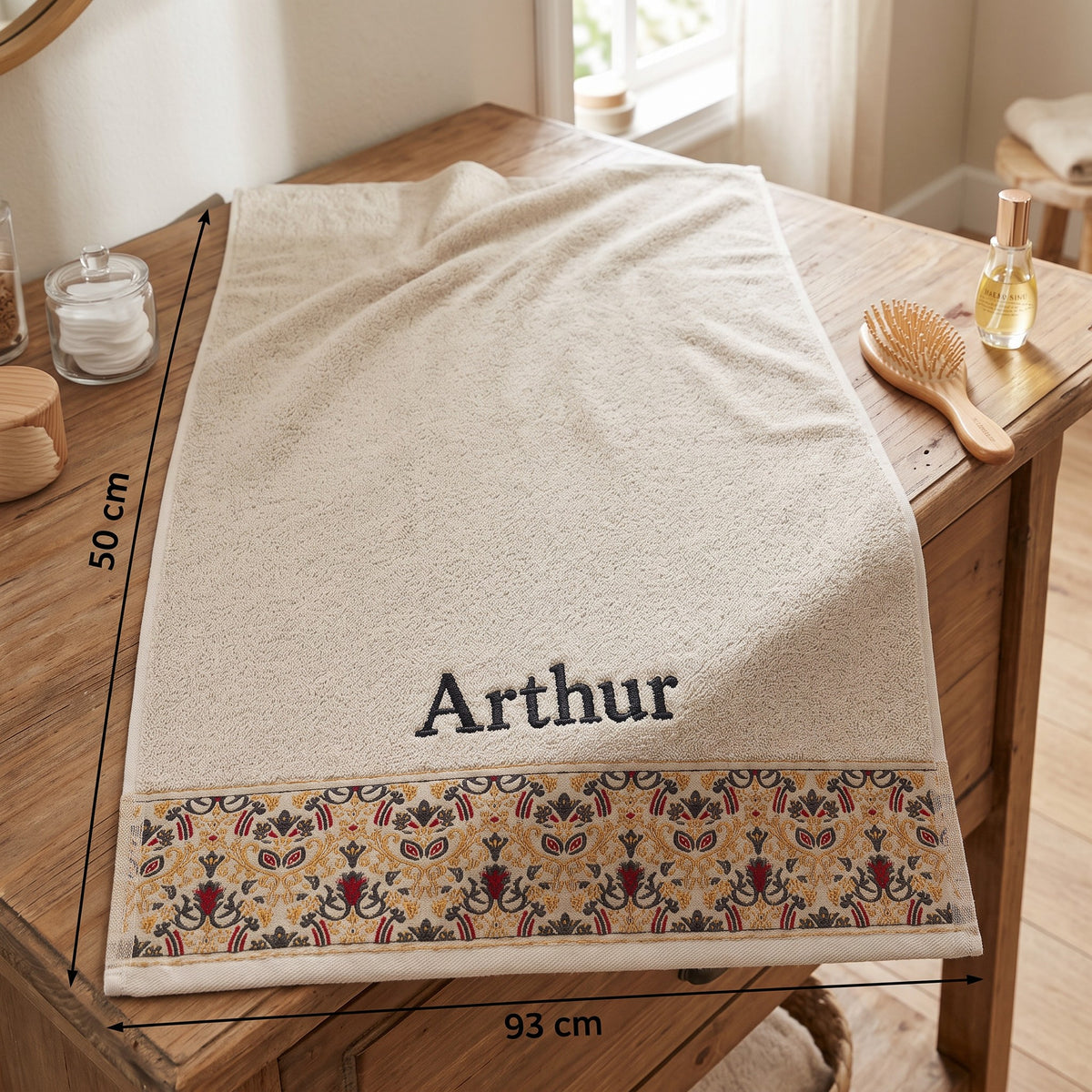 Arthur personalized hair towel, charcoal grey serif embroidery on cream cotton with a patterned border — photo 2