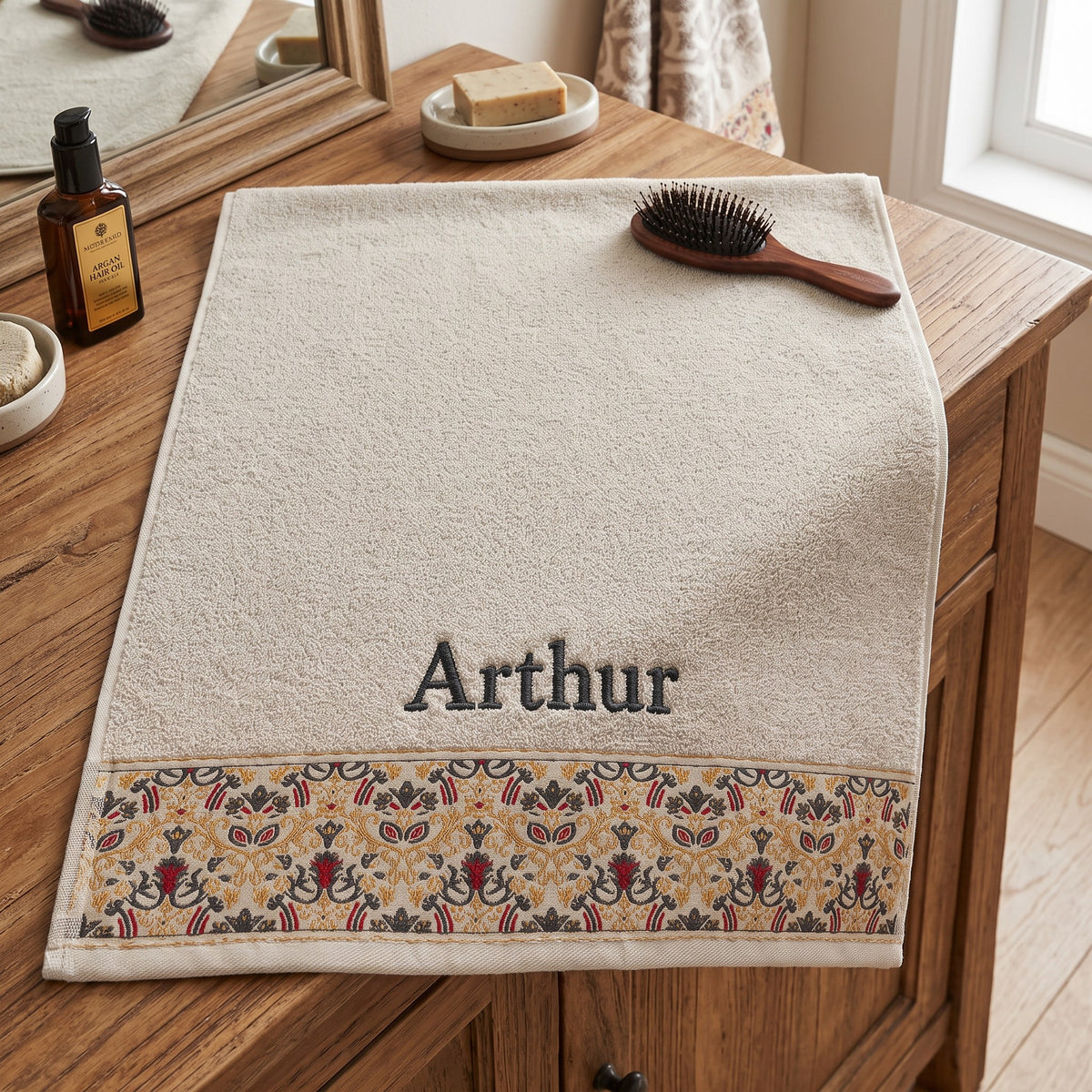 Arthur personalized hair towel, charcoal grey serif embroidery on cream cotton with a patterned border — photo 3